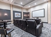 Thumbnail 20 of 23 - a large screening room with leather chairs and a projector screen