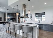 Thumbnail 23 of 23 - a large kitchen with an island and bar stools
