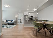 Thumbnail 7 of 42 - A modern kitchen with a dining table and chairs.