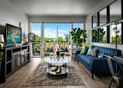Thumbnail 6 of 15 - A living room with a blue couch and a coffee table.
