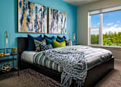 Thumbnail 7 of 15 - A bedroom with a bed, pillows, a blanket, and a painting on the wall.