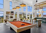 Thumbnail 9 of 28 - A pool table is in the middle of a room with a view of the mountains.