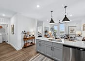 Thumbnail 20 of 28 - A modern kitchen with a large island and stainless steel appliances.