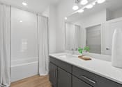 Thumbnail 5 of 17 - A bathroom with a white countertop and a large mirror.