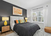 Thumbnail 6 of 17 - A bedroom with a large bed and a painting on the wall.