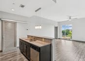 Thumbnail 10 of 32 - an open kitchen and living room with a large window and