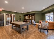 Thumbnail 45 of 68 - A room with a pool table and couches.
