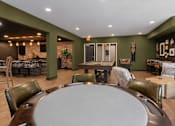 Thumbnail 44 of 68 - A large oval table is surrounded by chairs in a room with a brick wall.