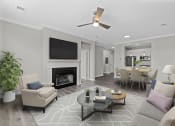 Thumbnail 14 of 21 - a living room with a fireplace and a table