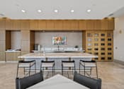 Thumbnail 10 of 41 - A kitchen with a dining table and chairs in the foreground.