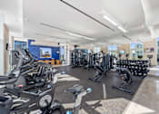 Thumbnail 20 of 41 - A gym with treadmills, stationary bikes, and other exercise equipment.