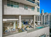 Thumbnail 4 of 41 - A modern building with a pool on the roof.