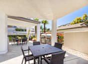 Thumbnail 6 of 33 - A patio with a table and chairs is shown.