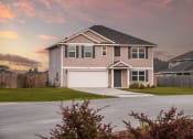 Thumbnail 32 of 40 - a house with a sunset in the background