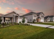 Thumbnail 1 of 40 - a row of houses with a sunset in the background