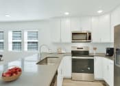 Thumbnail 40 of 51 - a kitchen with white cabinets and stainless steel appliances