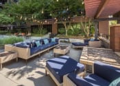 Thumbnail 26 of 44 - Patio with couches and chairs an d a fire pit at The Wyatt, Portland, OR