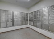Thumbnail 24 of 24 - A room with a row of mailboxes on the wall.