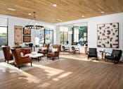 Thumbnail 7 of 27 - A living room with wooden floors and a variety of chairs.