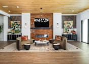Thumbnail 9 of 27 - A living room with a fireplace and a couch.