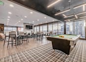 Thumbnail 8 of 30 - a games room with a pool table and a view of the city