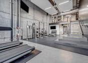 Thumbnail 5 of 30 - the lobby of a gym with stairs and a tv