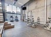 Thumbnail 4 of 30 - a gym with weights machines and a large window