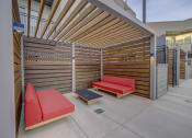 Thumbnail 18 of 26 - a lounge area with two couches and a coffee table in front of a building