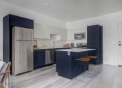 Thumbnail 6 of 26 - Modern kitchen with island at The Opal apartments in West Valley City near Salt Lake City, UT