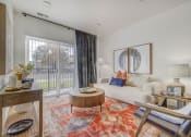 Thumbnail 3 of 26 - a living room with a white couch and a sliding glass door