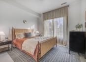 Thumbnail 2 of 26 - a bedroom with a bed and a large window