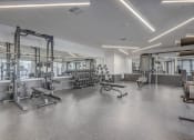 Thumbnail 9 of 26 - a gym with weights machines and other exercise equipment in a building