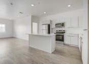 Thumbnail 20 of 26 - an empty kitchen with white cabinets and a white counter top