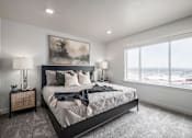 Thumbnail 16 of 26 - A bedroom with a large bed and a painting on the wall.
