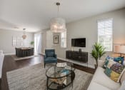 Thumbnail 15 of 23 - a living room with a couch and a coffee table