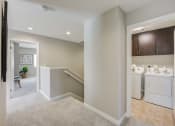 Thumbnail 23 of 23 - a utility room with a washer and dryer and a laundry room with stairs