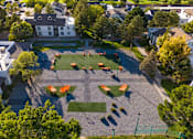 Thumbnail 22 of 51 - an aerial view of a playground in a neighborhood with trees