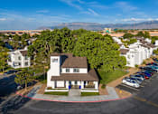 Thumbnail 21 of 51 - an aerial view of a large white house with a brown roof and a parking lot