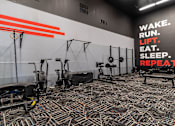Thumbnail 18 of 51 - a gym with exercise equipment and a sign that reads wake run lift sleep