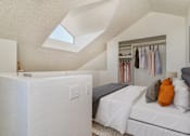 Thumbnail 7 of 51 - two beds in a room with a closet and a skylight