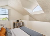 Thumbnail 8 of 51 - a bedroom with a bed and a desk with a window