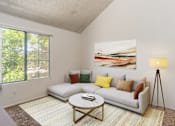 Thumbnail 10 of 51 - a living room with a couch and a coffee table