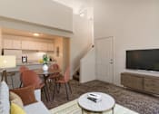 Thumbnail 6 of 51 - a living room with a couch and a table and a television