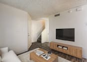 Thumbnail 43 of 51 - A living room with a staircase leading to the second floor.