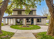 Thumbnail 29 of 51 - a house with a fountain in the center of a circle of grass