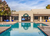 Thumbnail 3 of 51 - a swimming pool in front of a hotel with a building