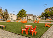 Thumbnail 37 of 51 - an outdoor seating area with tables and chairs on the grass