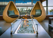 Thumbnail 15 of 30 - Outdoor Fireplace and Seating Area at AV8 Apartments in San Diego, CA