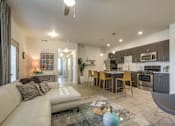 Thumbnail 2 of 34 - furnished model living room and kitchen