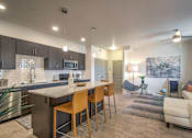 Thumbnail 3 of 34 - furnished model living room and kitchen